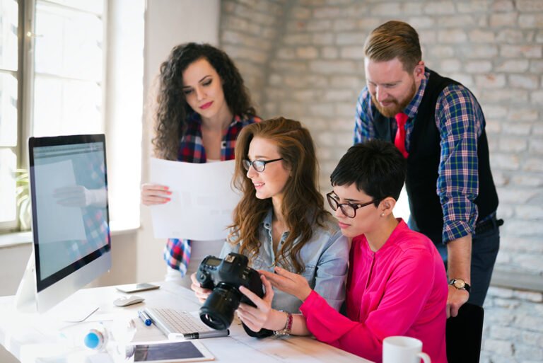 Picture of young attractive architects discussing in office